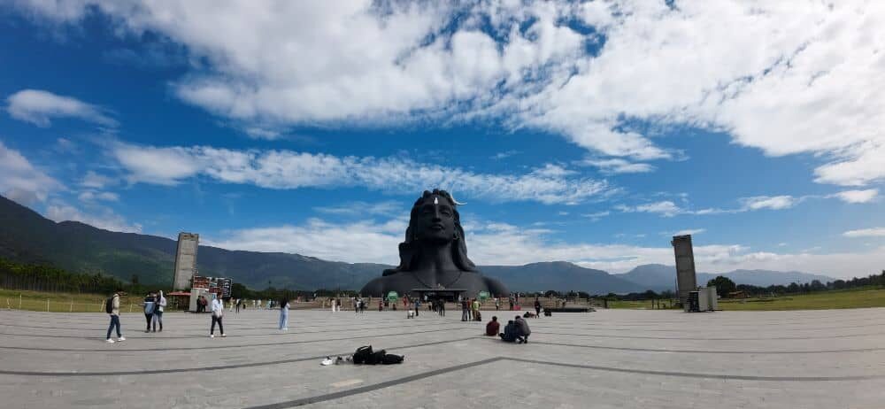 Recent Adiyogi picture showing blue skies filled with white clouds above and the stone pathway in front of Him @ Isha Center, Coimbatore